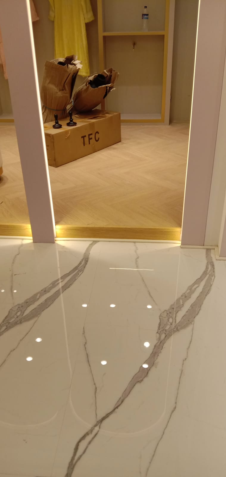 Statuario Marble to Herringbone Wood Floor Transition